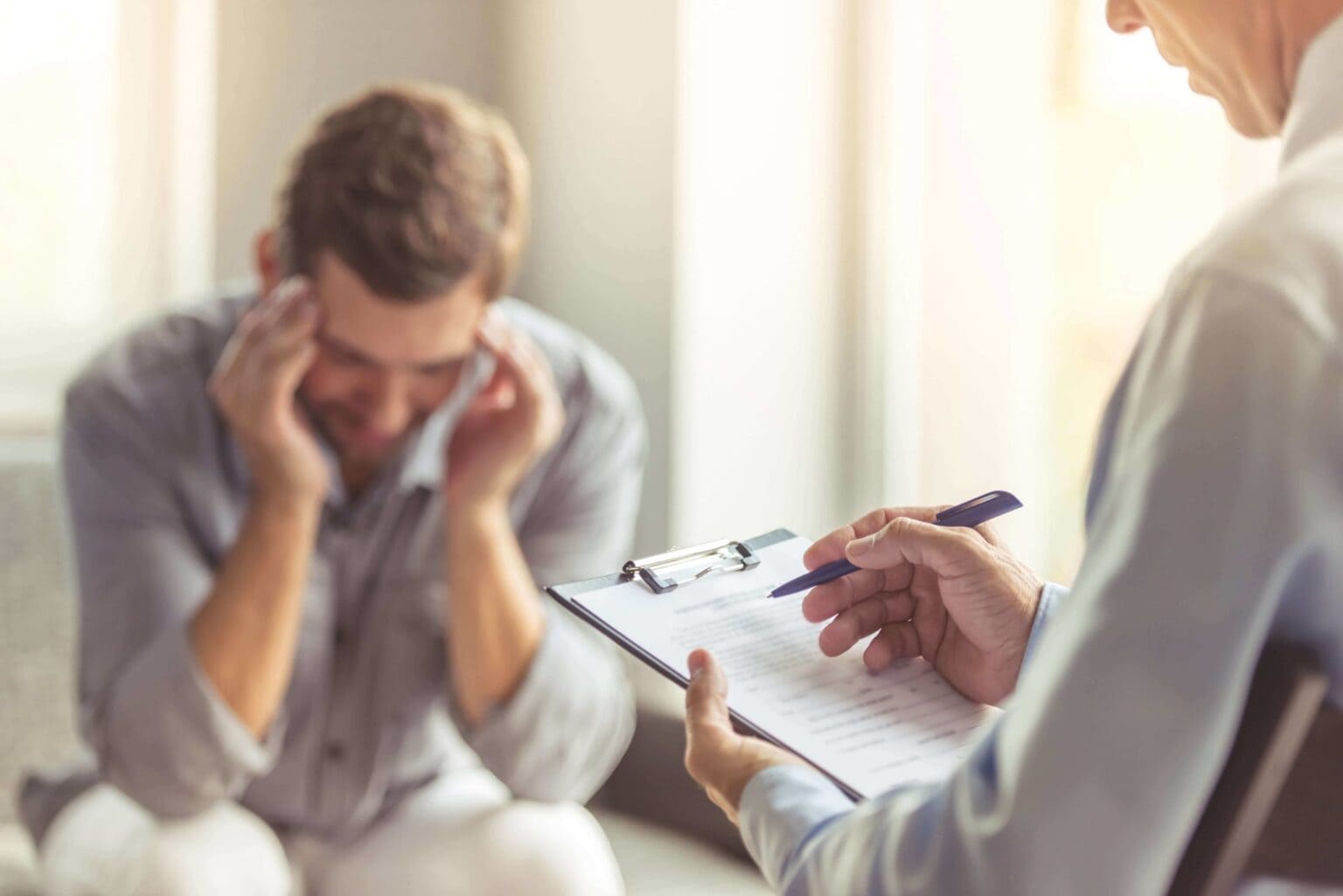 man in therapy discussing addiction and mental illness